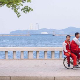 Cycling past, Wonsan, North Korea
