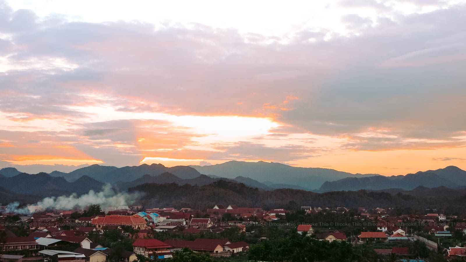 Panoramic view of sunset with crepuscular rays over Luang Prabang, Laos. Seen from Luang Prabang View Hotel